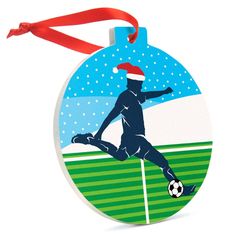 a christmas ornament with a soccer player on it's side and a red ribbon