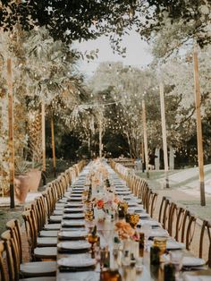 a long table is set up for an outdoor dinner