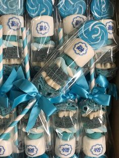 blue and white cookies wrapped in clear cellophane with bows on them are displayed