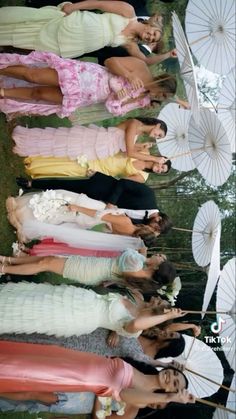 a group of young women standing next to each other in dresses and umbrella's