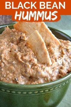 black bean hummus in a green bowl with tortilla chips