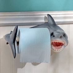 a close up of a toilet paper holder with a shark head on it