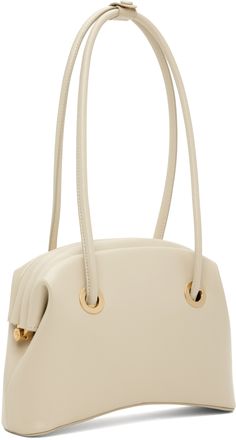 Cracked leather shoulder bag in beige. · Twin rolled shoulder straps · Gold-tone logo stamp at back face · Curved base · Hinged closure · Patch pocket at interior · Cotton twill lining · Logo-engraved gold-tone hardware · H7 x W10 x D3 in Supplier color: Washed beige Modern Cream Shoulder Bag With Gold-tone Hardware, Timeless Beige Shoulder Bag With Gold-tone Hardware, Classic Cream Shoulder Bag With Gold-tone Hardware, Timeless Cream Shoulder Bag With Double Handle, Beige Shoulder Bag With Gold-tone Hardware And Double Handle, Cream Shoulder Bag With Gold-tone Hardware For Office, Classic Beige Shoulder Bag With Gold-tone Hardware, Cream Shoulder Bag With Gold-tone Hardware And Double Handle, Cream Satchel With Gold-tone Hardware For Office