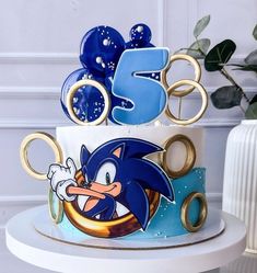 a sonic the hedgehog birthday cake is decorated with gold and blue icing,