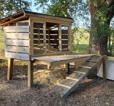 a chicken coop built into the side of a tree