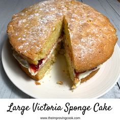 a large victoria sponge cake cut in half on a white plate with the words, large victoria sponge cake