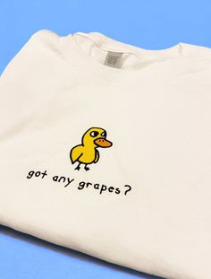 "got any grapes? Duck Shirt/Sweatshirt/Hoodie got any grapes? Inspired by the iconic \"Duck Song\". Made of a premium quality cotton blend for a great quality soft feel, and comfortable retail fit. Our embroidery is crafted for long-lasting quality so your garment stays looking fantastic. Fabric: Shirt: 100 % Cotton Sweatshirt: 50% Cotton 50% Polyester Hoodie: 80% Cotton 20% Polyester Weight: Shirt: 180 GSM Sweatshirt and Hoodie: 280 gsm Shop With Total Confidence - If something's not quite righ Got Any Grapes Duck, Fun Clothes Aesthetic, Cute Funny Sweatshirts, Thrift Sweatshirts, Fun Merch Ideas, Duck Things To Buy, Painting On Sweatshirts, How To Style Sweatshirt, Recently Viewed By Me Today