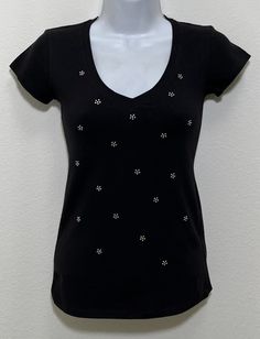 Fabric comprised of 95% cotton and 5% spandex.  Handmade rhinestone t-shirts made in the United States with quality rhinestones. Machine Washable. T-shirt style is a fitted V-neck cap sleeve. AB stands for Aurora Borealis; this is the type of rhinestone used on our T-shirt creating a unique multi-dimensional shine. Size Range:         XXS = 2         XS = 4         S = 6         M = 8         L = 10         XL = 12 Embellished Fitted Cotton T-shirt, Summer Black Embellished T-shirt, Spring Short Sleeve Rhinestone T-shirt, Fitted Black Embellished T-shirt, Black Cotton T-shirt With Rhinestones, Multi Dimensional, Womens Blouses, Cap Sleeve, Aurora Borealis