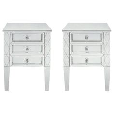 a pair of mirrored nightstands with drawers on each side and an open drawer in the middle