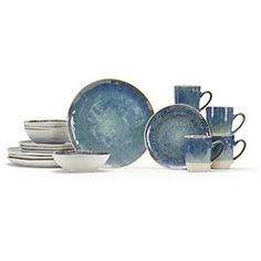 an assortment of blue and white dishes, cups and saucers on a white background