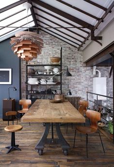 an industrial style dining room with exposed ceilings