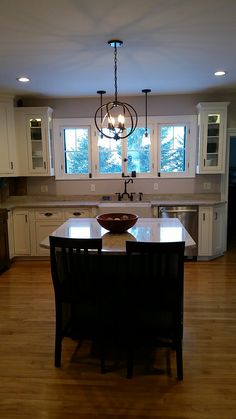 a large kitchen with an island in the middle