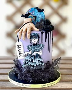 a cake decorated with an image of a woman holding a knife and tag on it