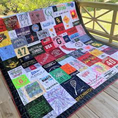 a quilt made with t - shirts on a deck