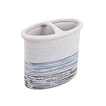 a white and blue ceramic toothbrush holder on a white background, with horizontal stripes