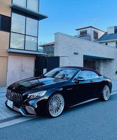 a black car parked in front of a building