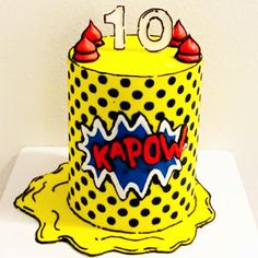 a birthday cake with the number 10 on it's top is decorated in yellow and black polka dots