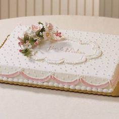 a cake decorated with flowers on top of a table