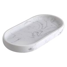 an oval white marble tray on a white background