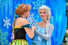 two women dressed as frozen princesses talking to each other