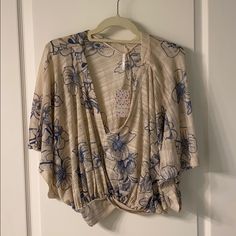 Beautiful Tan And Blue Shirt Free People Shirt! Never Worn! New With Tags! Perfect With A Blue Bandeau And Jeans. Perfect Christmas Gift And Great For Summer! Willing To Negotiate Price :) Beige V-neck Summer Top, Casual Cream V-neck Top, Beige Short Sleeve Tops For Vacation, Beige Short Sleeve Beach Tops, Casual Beige Floral Print Blouse, Casual Cream Tops With Floral Print, Casual Cream Floral Print Top, Cream Short Sleeve Top For Day Out, Cream Floral Print Tops For Spring