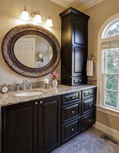 a large bathroom with double sinks and mirrors