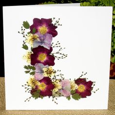 a white card with purple and yellow flowers on it