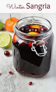 a glass jar filled with liquid and garnished with cherries