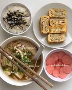 four bowls with different types of food in them, including rice and meat rolls on the side