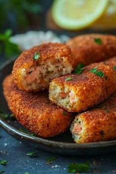 Golden-brown breaded fish croquettes garnished with parsley on a dark plate. Recipe For Salmon Croquettes, Baked Salmon Croquettes Oven, Salmon Croquettes Meal Ideas, Salmon Dip Recipes, Salmon Burger Recipe