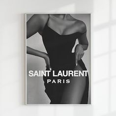 a black and white photo of a woman's legs with the words saint laurent paris on it