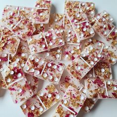 there are many small pieces of food with gold and white sprinkles on them