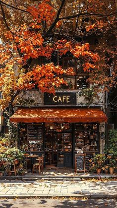 the cafe is surrounded by autumn foliage and trees with orange leaves on it's branches