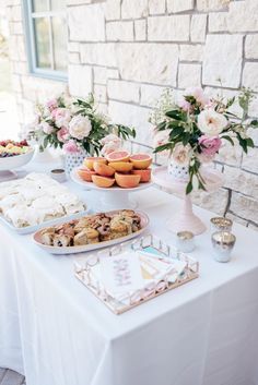 a table topped with lots of food and desserts