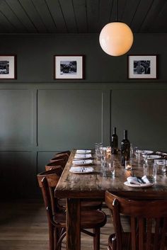 a long table with place settings and wine bottles