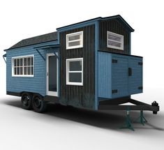 a tiny blue house sitting on top of a trailer