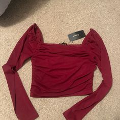 The Sleeves Are Mesh Red Fitted Top For Night Out, Trendy Stretch Red Blouse, Red Stretch Top For Date Night, Stretch Red Top For Date Night, Chic Red Fitted Top, Burgundy Long Sleeve Tops For Night Out, Fitted Burgundy Tops For Date Night, Red Stretch Blouse For Fall, Trendy Red Tops For Night Out