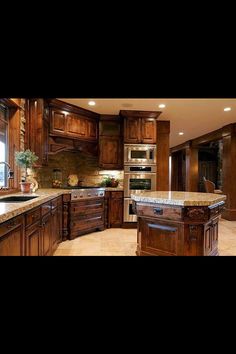 a large kitchen with wooden cabinets and marble counter tops