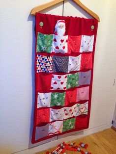 a quilt hanging on a wall next to some buttons