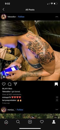 a woman with tattoos is looking at her cell phone