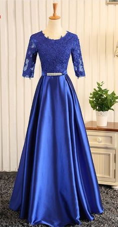 A royal blue ribbon evening gown with a woman's gown was worn for a formal evening gown Blue Satin Ball Gown For Prom, Blue Satin Prom Ball Gown, Royal Blue Fitted Gown For Debutante Ball, Fitted Royal Blue Gown For Debutante Ball, Fitted Royal Blue Ball Gown For Prom Season, Blue Satin Ball Gown For Debutante Ball, Blue Prom Evening Dress With Corset Back, Blue Gown With Corset Back For Prom, Fitted Blue Ball Gown With Corset Back