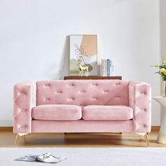 a living room with a pink velvet couch