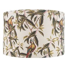 a lamp shade with birds and leaves on it