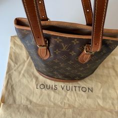 Louis Vuittonmonogram Petit Bucket Bag |Pre-Owned; Bag Completely Relined Inside Professionally At Lv Store - Inside Is Completely New; As Shown On Pictures|Good Condition|Tarnishing On Hardware|Light Scuff Marks On Bottom Outside As Shown On Pictures|Color: Brown Monogram|Height: 10”|Depth: 5.25”|Width: 10”|Shoulder Strap Drop: 10.25”||| Lv Store, Louis Vuitton Bags, Louis Vuitton Monogram, Bucket Bag, Shoulder Strap, Bag Lady, Louis Vuitton, Monogram, Color