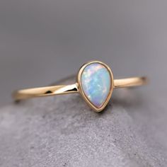 Minimalist Pear Shaped Opal Ring Teardrop Opal Ring, Elegant Teardrop Opal Ring As Gift, Elegant Teardrop Opal Ring Gift, Elegant Pear-shaped Opal Ring As Gift, Elegant Pear-shaped Opal Gift Ring, Opal Ring With Bezel Setting Gift, Minimalist Opal Ring For Formal Occasions, Fine Jewelry Opal Ring With Round Band, Gold Pear-shaped Opal Ring Gift