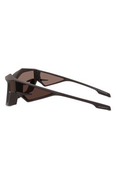 Exaggerated geometric frames lend futuristic flair to these stylish sunglasses with smoky-tinted, UV-protective lenses. 100% UV protection Acetate Imported Modern Shield Sunglasses With Uv Protection, Modern Brown Sunglasses For Outdoor, Modern Brown Shield Sunglasses With Gradient Lenses, Brown Cat Eye Shield Sunglasses With Uva Protection, Modern Brown Shield Sunglasses For Outdoor, Modern Brown Shield Sunglasses With Uv Protection, Stylish Sunglasses, Uv Protection, Dark Brown