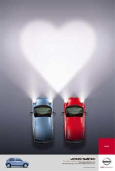 two cars in front of a heart shaped light