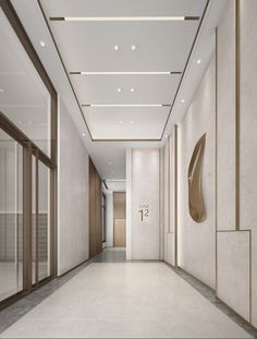 an empty hallway with white walls and flooring is seen in this image, there are two elevators on either side of the wall