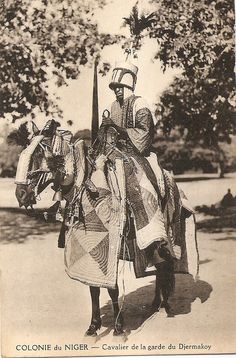 an old black and white photo of a person on a horse