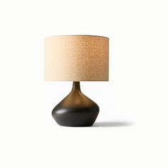 a black table lamp with a beige shade